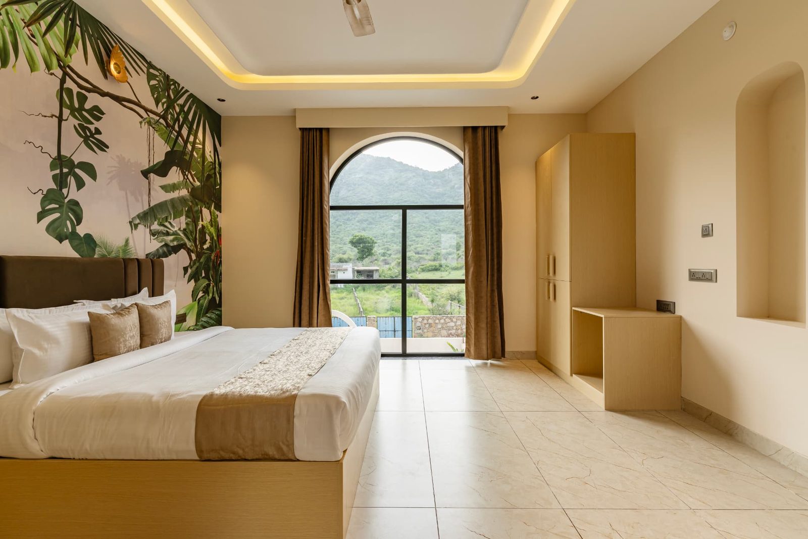 Bedroom with arched window overlooking the hills