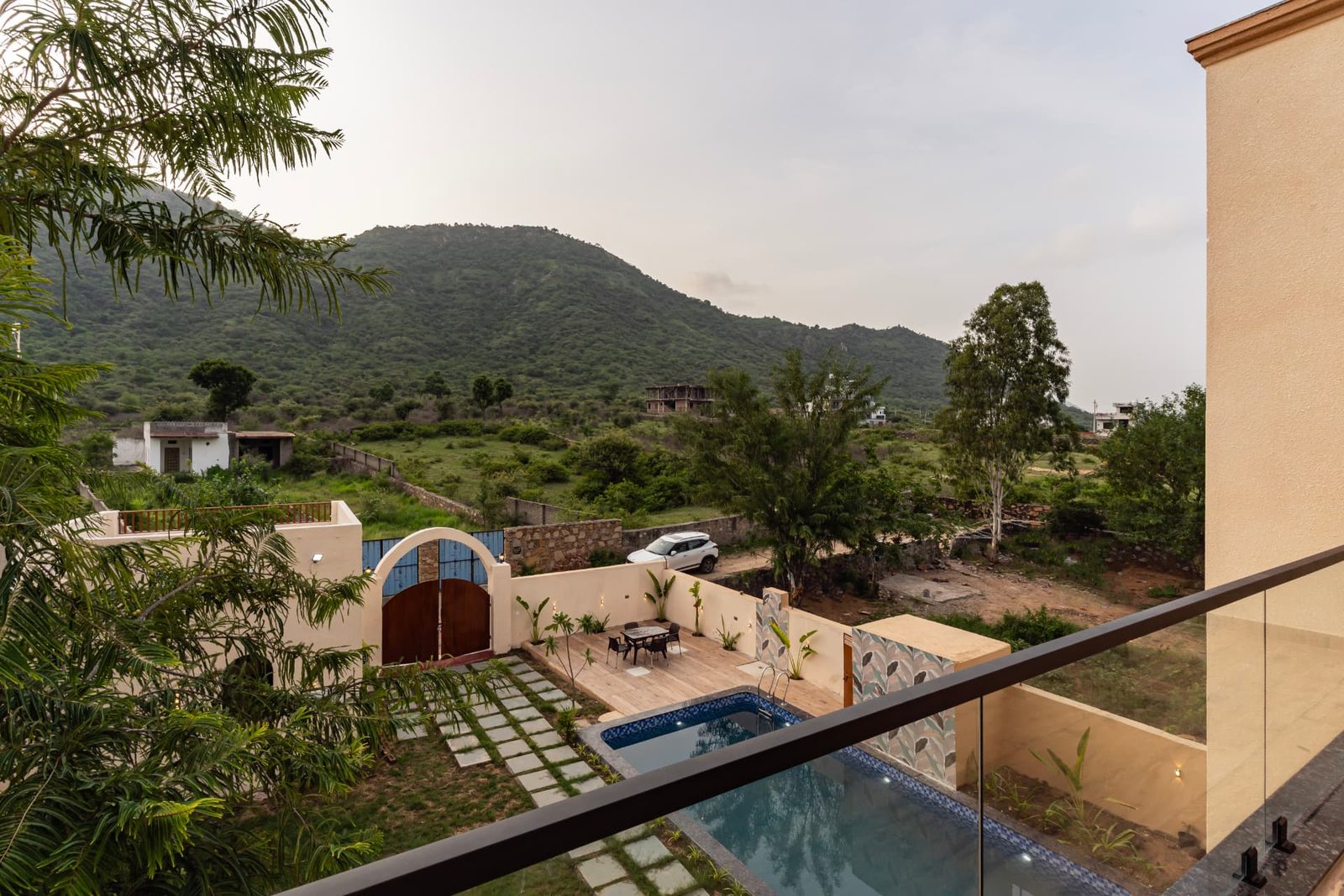 Balcony view over the pool towards the Aravalli hills