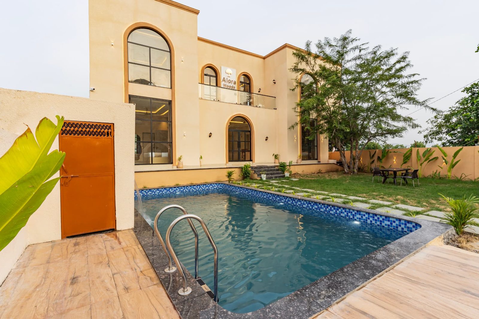 Private swimming pool with wooden deck at Alora Woods Villa